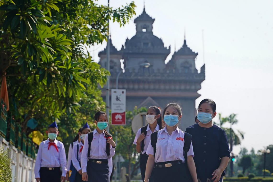 Students entering the gates of their school