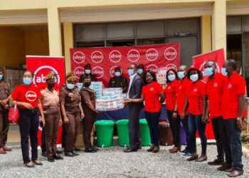 Absa Bank employees presenting the items to officials of the Senior Correctional Centre_