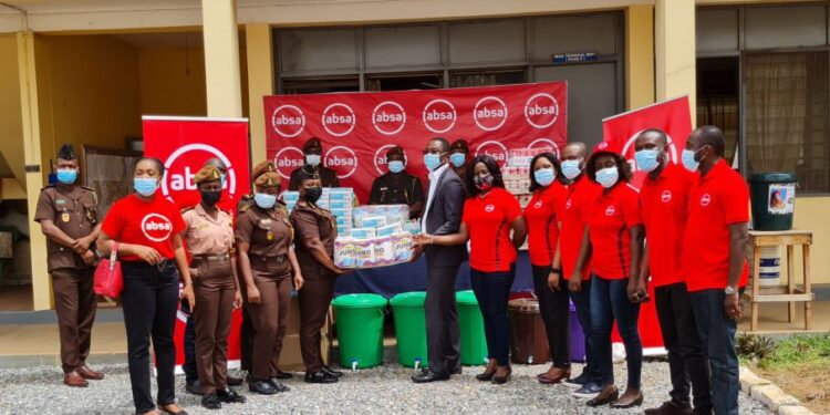 Absa Bank employees presenting the items to officials of the Senior Correctional Centre_