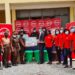Absa Bank employees presenting the items to officials of the Senior Correctional Centre_