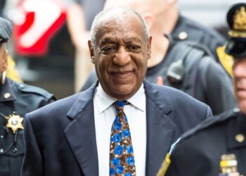 Bill Cosby flanked by security men-GETTY IMAGE