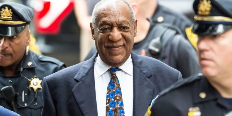 Bill Cosby flanked by security men-GETTY IMAGE