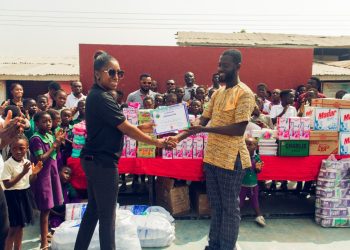 Country Manager of Silverbird Cinemas Ghana, Funmi Onuma presenting items to Edward Honest Polley, Administrator of Savior Children Foundation